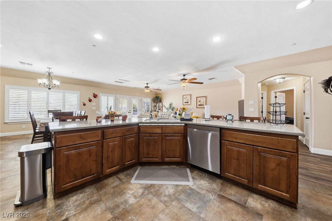 1285 Embry Avenue Moapa, NV 89025 - Photo 38 of 98 Kitchen featuring stainless steel dishwasher, recessed lighting, a chandelier, arched walkways, and light stone countertops