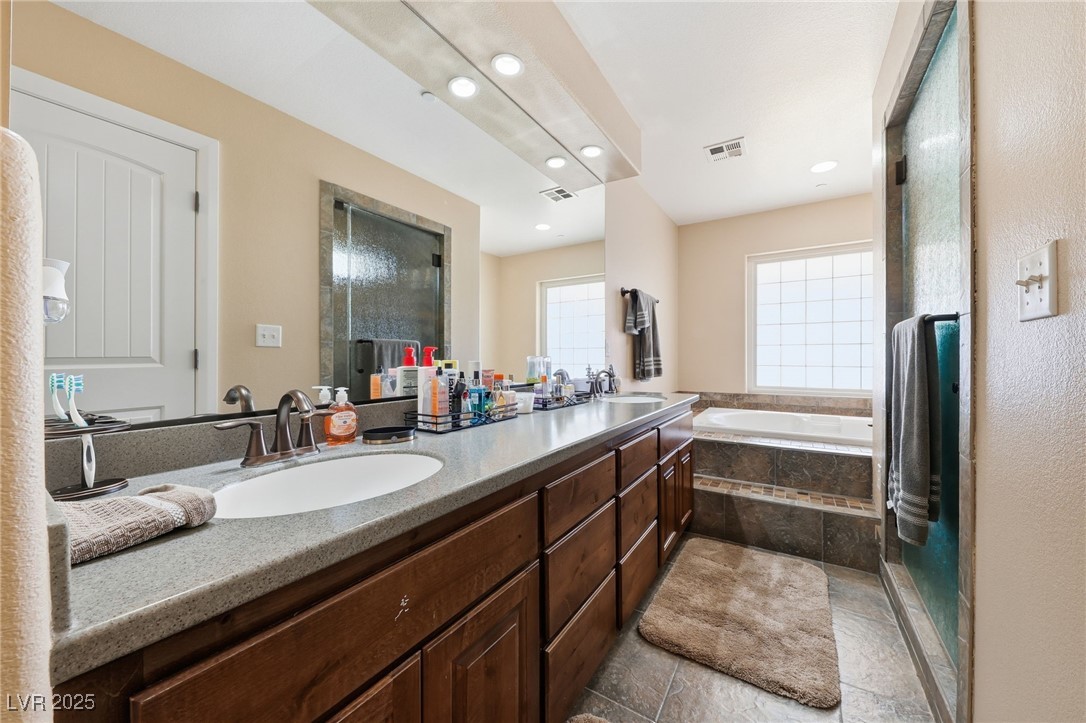 1285 Embry Avenue Moapa, NV 89025 - Photo 44 of 98 Bathroom with a shower stall, double vanity, a garden tub, recessed lighting, and light tile patterned floors