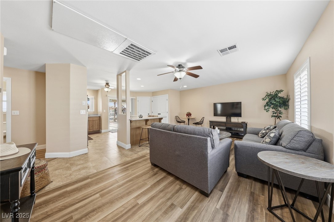 1285 Embry Avenue Moapa, NV 89025 - Photo 57 of 98 Living room with healthy amount of natural light, a ceiling fan, recessed lighting, and light wood-style flooring