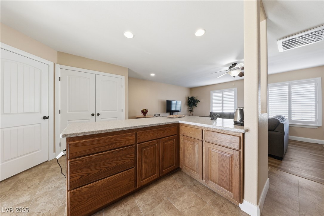 1285 Embry Avenue Moapa, NV 89025 - Photo 98 of 98 Kitchen with open floor plan, recessed lighting, brown cabinets, ceiling fan, and a peninsula