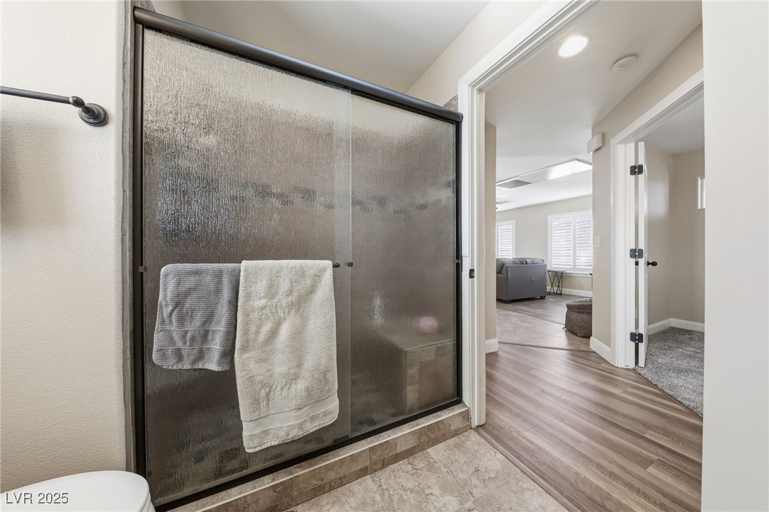 1285 Embry Avenue Moapa, NV 89025 - Photo 66 of 98 Bathroom featuring a stall shower and wood finished floors