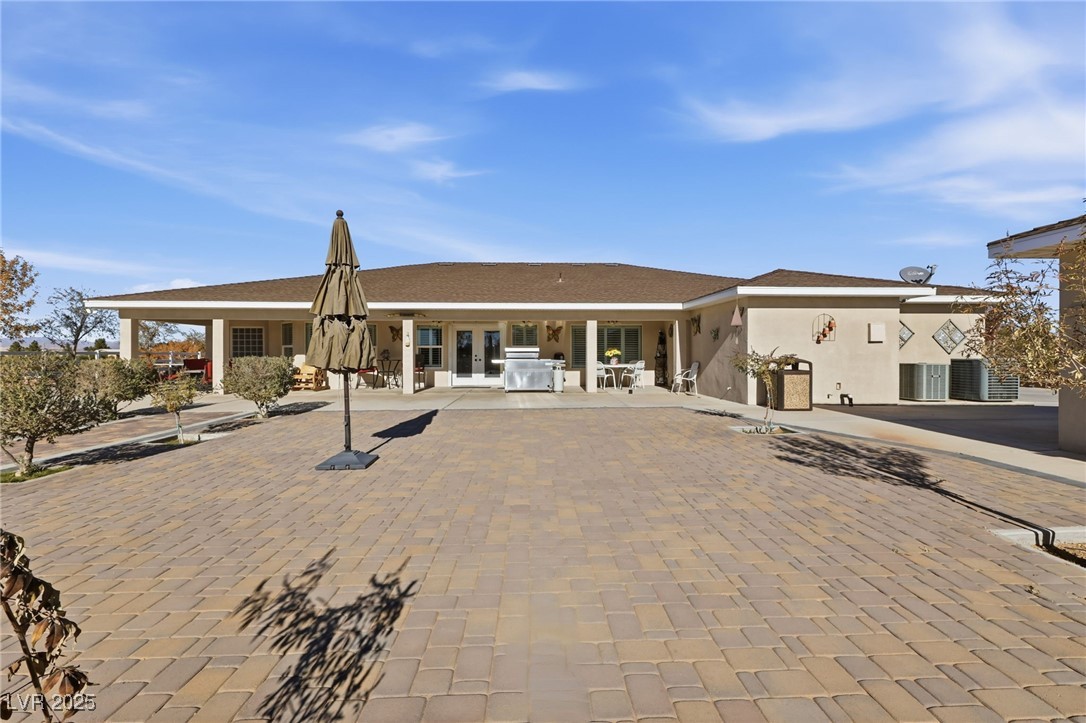 1285 Embry Avenue Moapa, NV 89025 - Photo 71 of 98 Rear view of property with stucco siding and roof with shingles