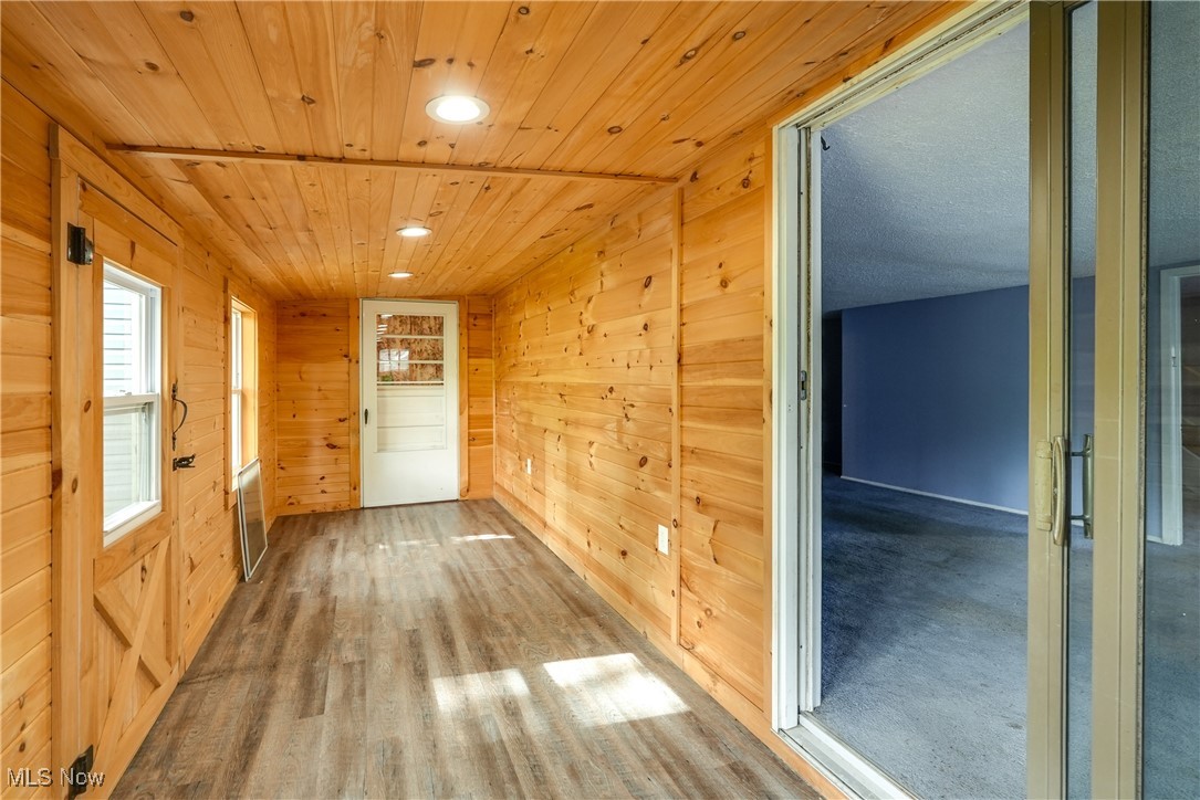 2123 Martin Road Mogadore, OH 44260 - Photo 8 of 35 Hallway with wooden walls, recessed lighting, wood ceiling, and wood finished floors