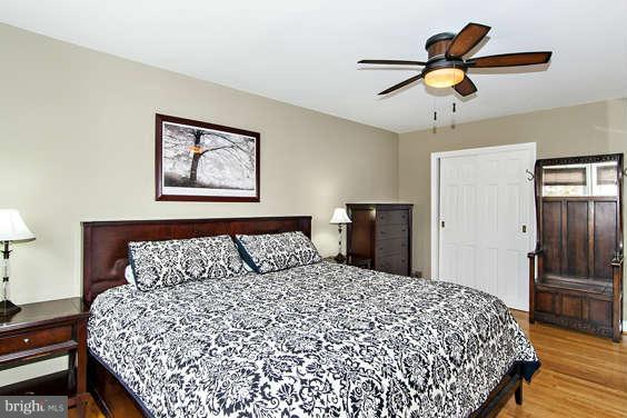 327 Whitfield Road Baltimore, MD 21228 - Photo 14 of 25 a bedroom with a bed and a chandelier