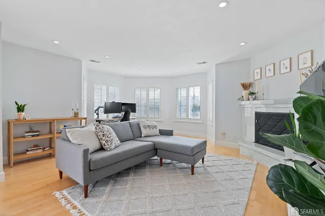 a living room with furniture and a fireplace