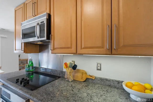a kitchen with stainless steel appliances granite countertop a sink and a granite counter tops