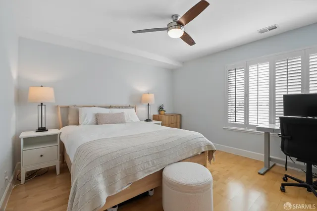 a bedroom with a bed a table and chair