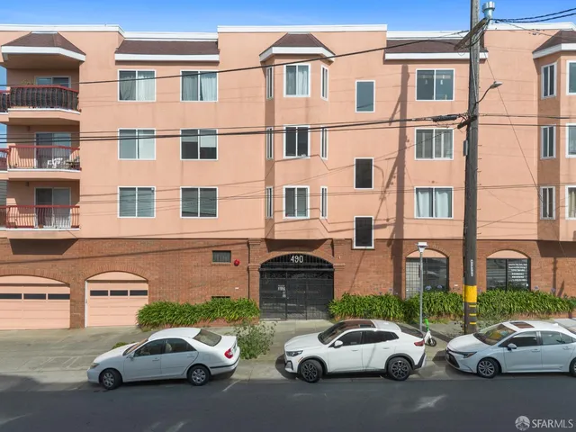 a couple of cars parked in front of a building