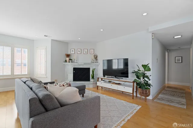 a living room with furniture flat screen tv and a fireplace