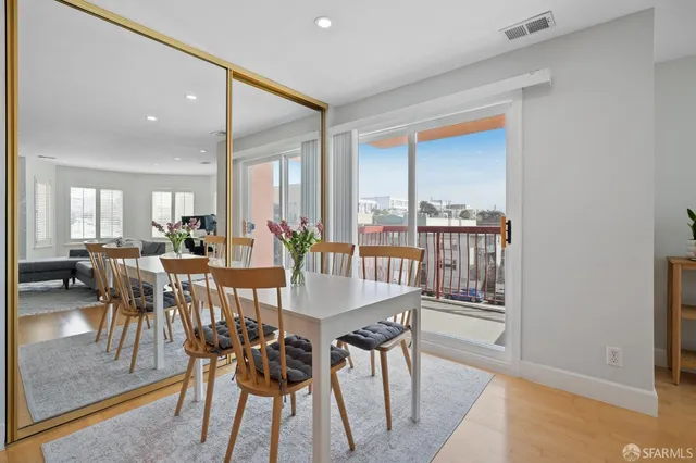 a view of a dining room with furniture and a potted plant