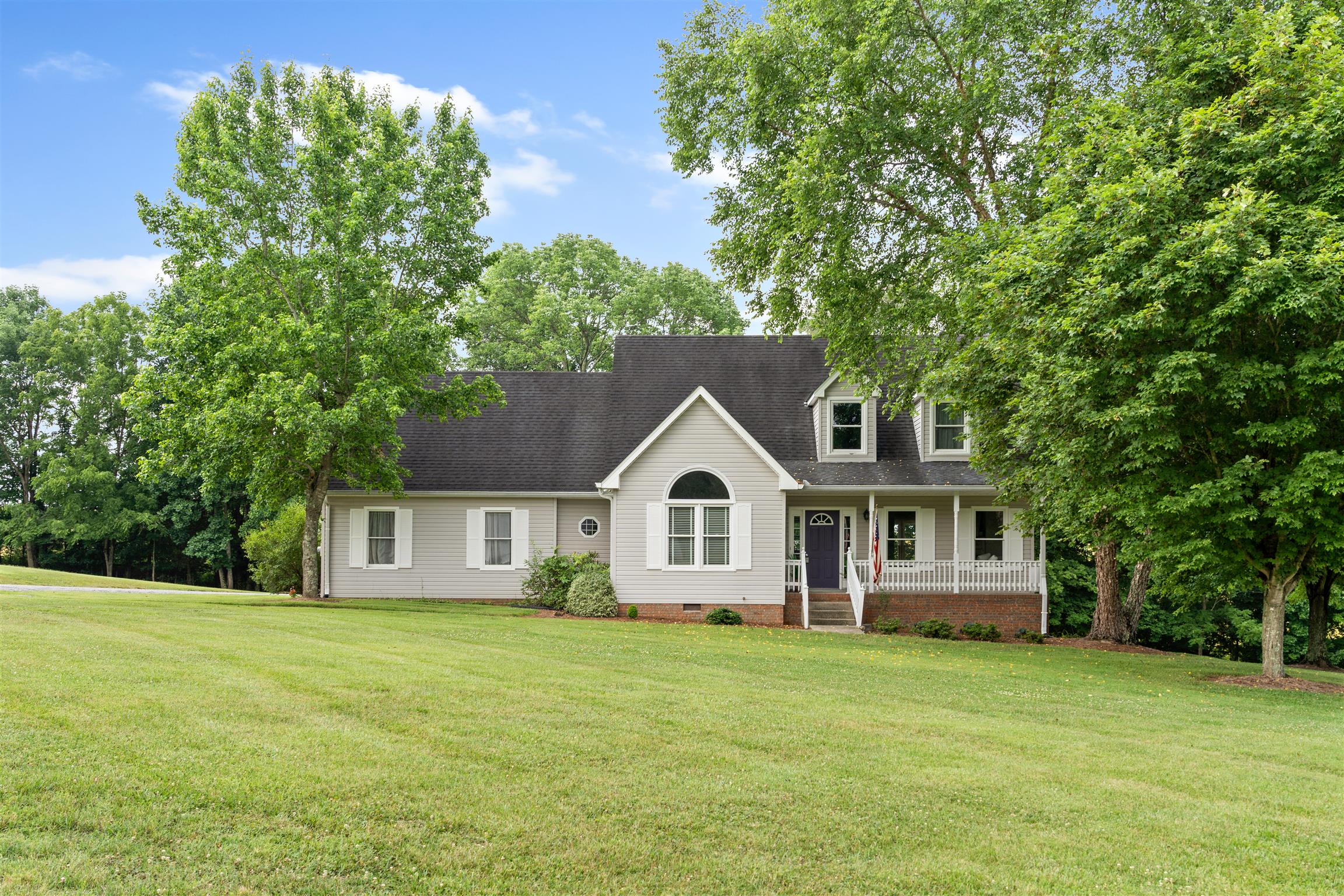 Oversized front yard with mature trees