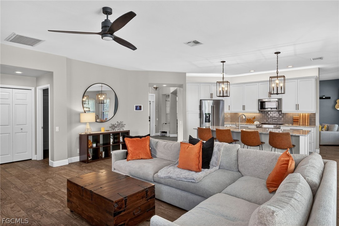 22866 Forest Ridge Drive Estero, FL 33928 - Photo 8 of 38 a living room with furniture kitchen view and a chandelier