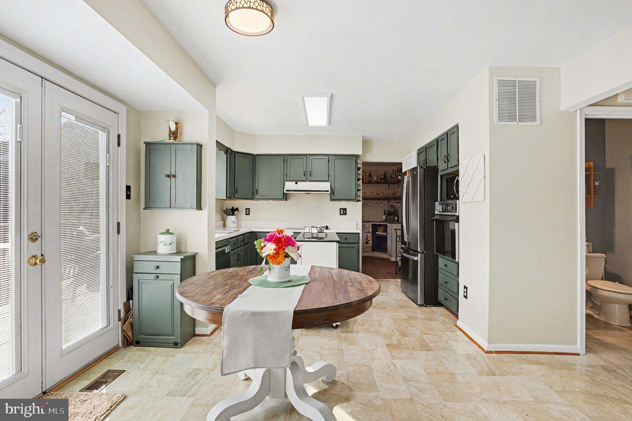4400 Cottington Road Nottingham, MD 21236 - Photo 12 of 48 a kitchen with a refrigerator and a sink