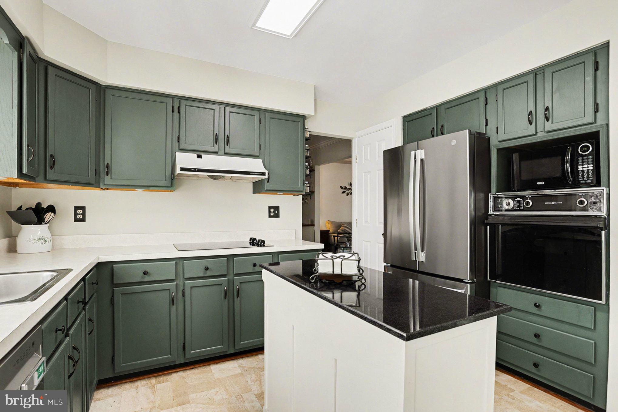 4400 Cottington Road Nottingham, MD 21236 - Photo 14 of 48 a kitchen with a sink a refrigerator and cabinets