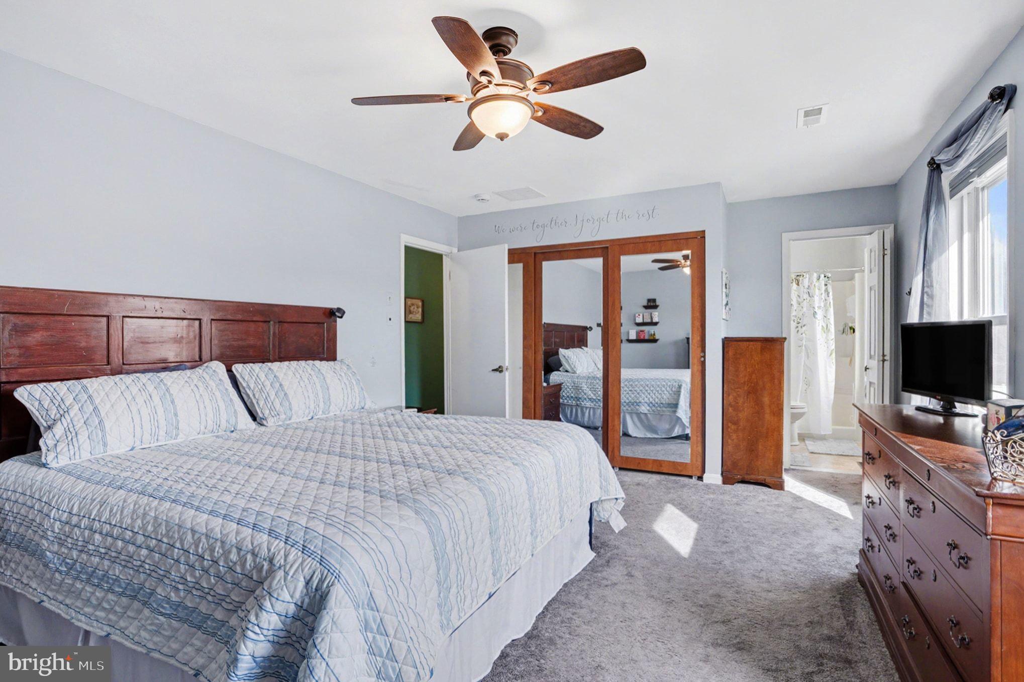 4400 Cottington Road Nottingham, MD 21236 - Photo 21 of 48 a bedroom with a bed flat screen tv and a chandelier