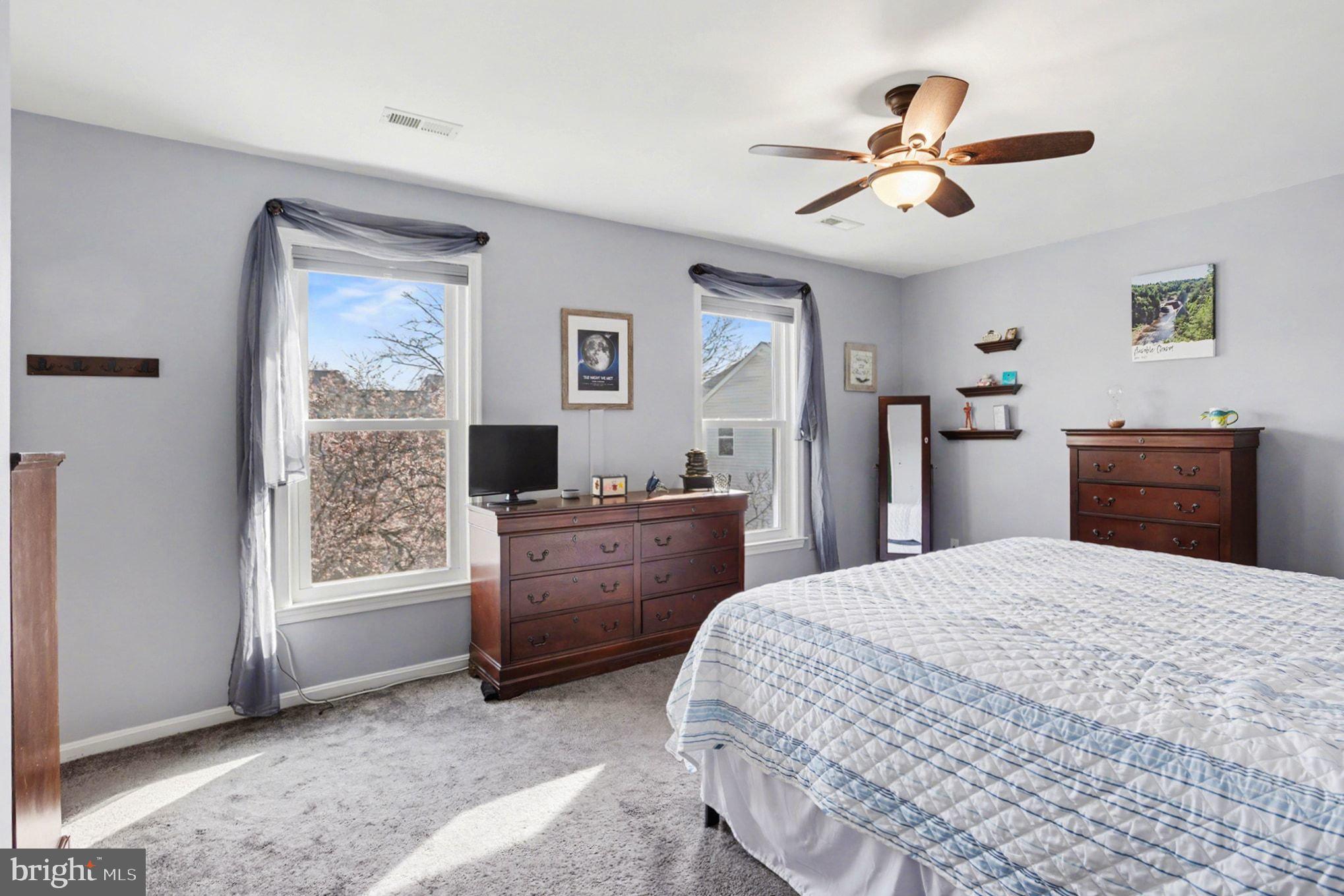 4400 Cottington Road Nottingham, MD 21236 - Photo 22 of 48 a bedroom with a bed and a chandelier