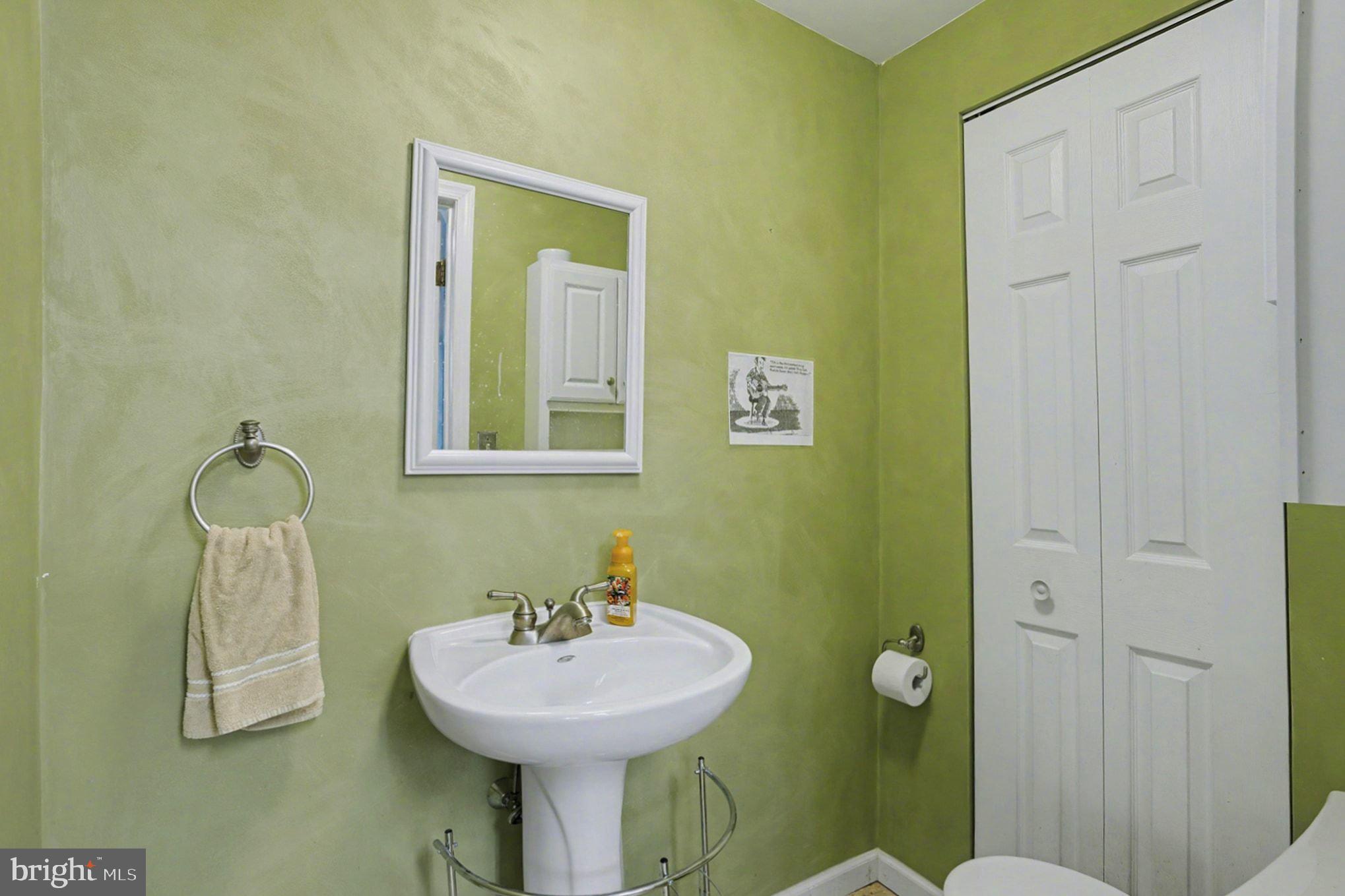 4400 Cottington Road Nottingham, MD 21236 - Photo 38 of 48 a bathroom with a sink a toilet and mirror