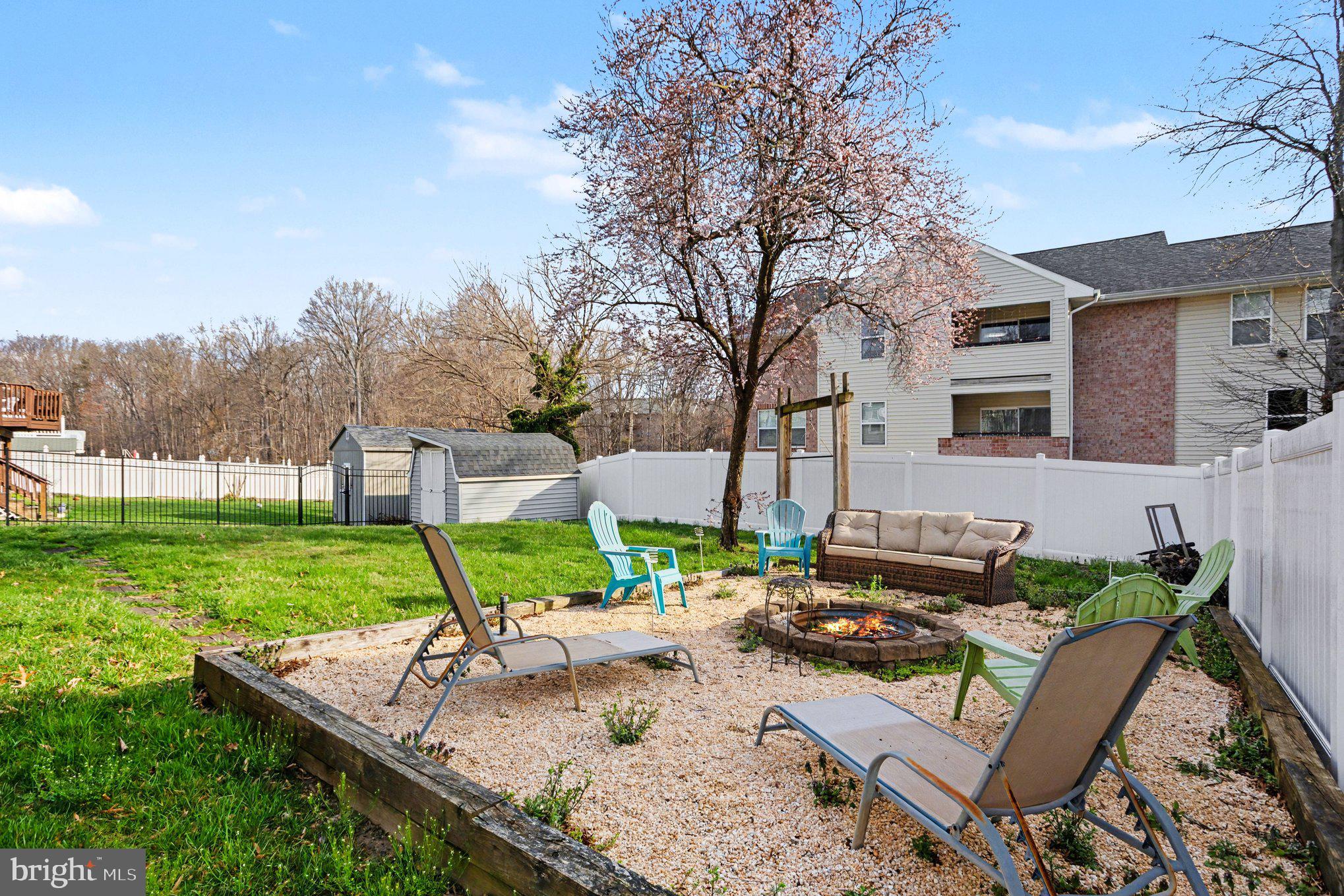 4400 Cottington Road Nottingham, MD 21236 - Photo 42 of 48 a view of a backyard with couches plants and large trees