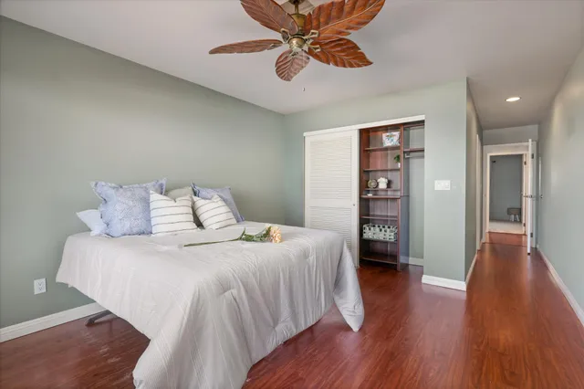 a spacious bedroom with a bed and a book shelf