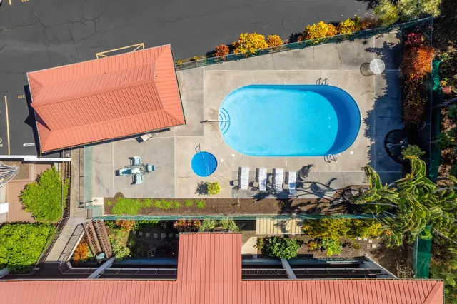 a bedroom with a bed table and a large window