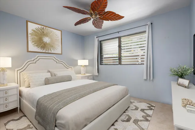 a bedroom with a bed and a painting on the wall