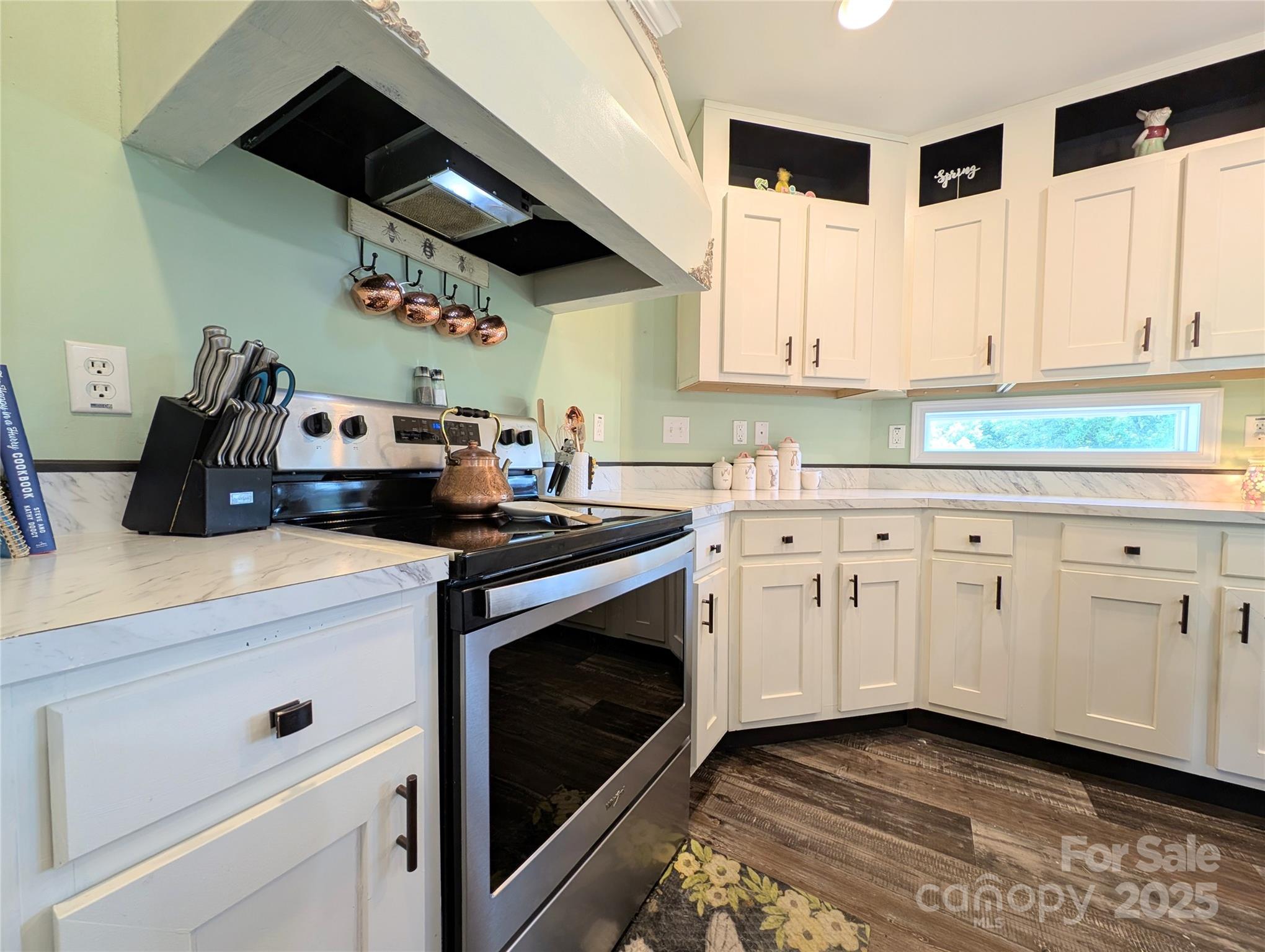 4713 White Store Road Wingate, NC 28174 - Photo 8 of 44 a kitchen with granite countertop a stove a sink and dishwasher with white cabinets