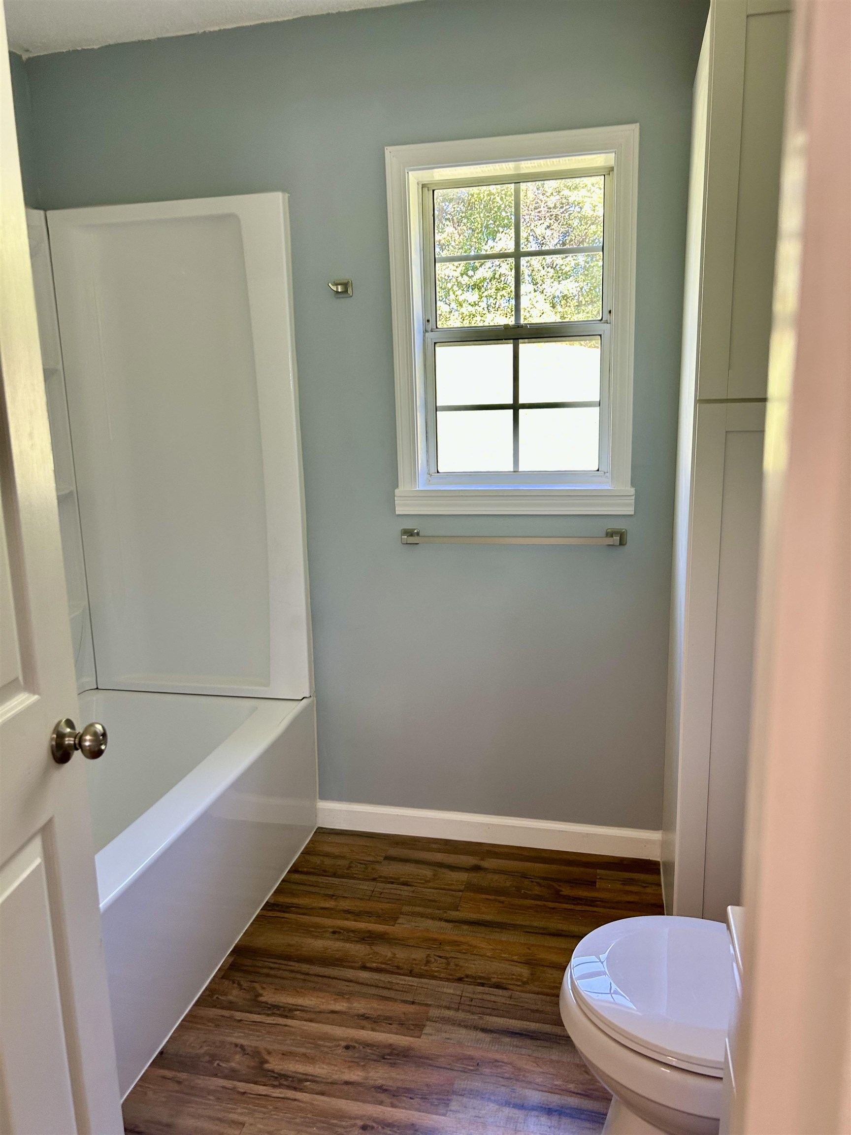 622 Bluebird Hill Road Ripley, TN 38063 - Photo 8 of 14 Bathroom featuring dark wood-style flooring and washtub / shower combination