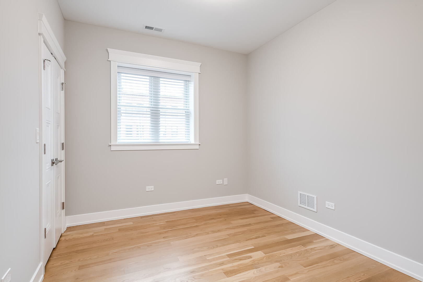 2145 South Halsted Street, Unit 4S Chicago, IL 60608 - Photo 18 of 29 an empty room with wooden floor and windows