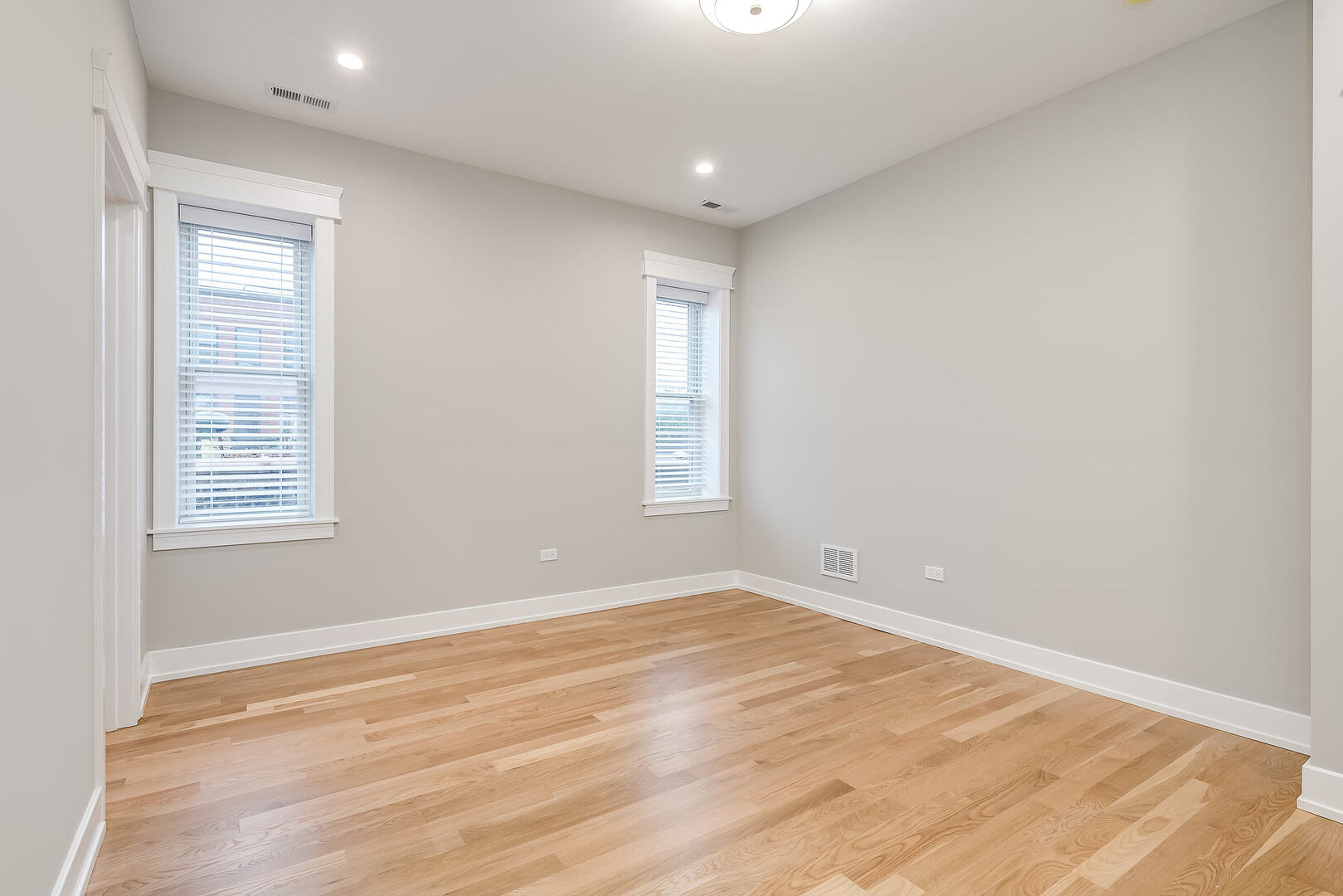 2145 South Halsted Street, Unit 4S Chicago, IL 60608 - Photo 23 of 29 an empty room with wooden floor and windows