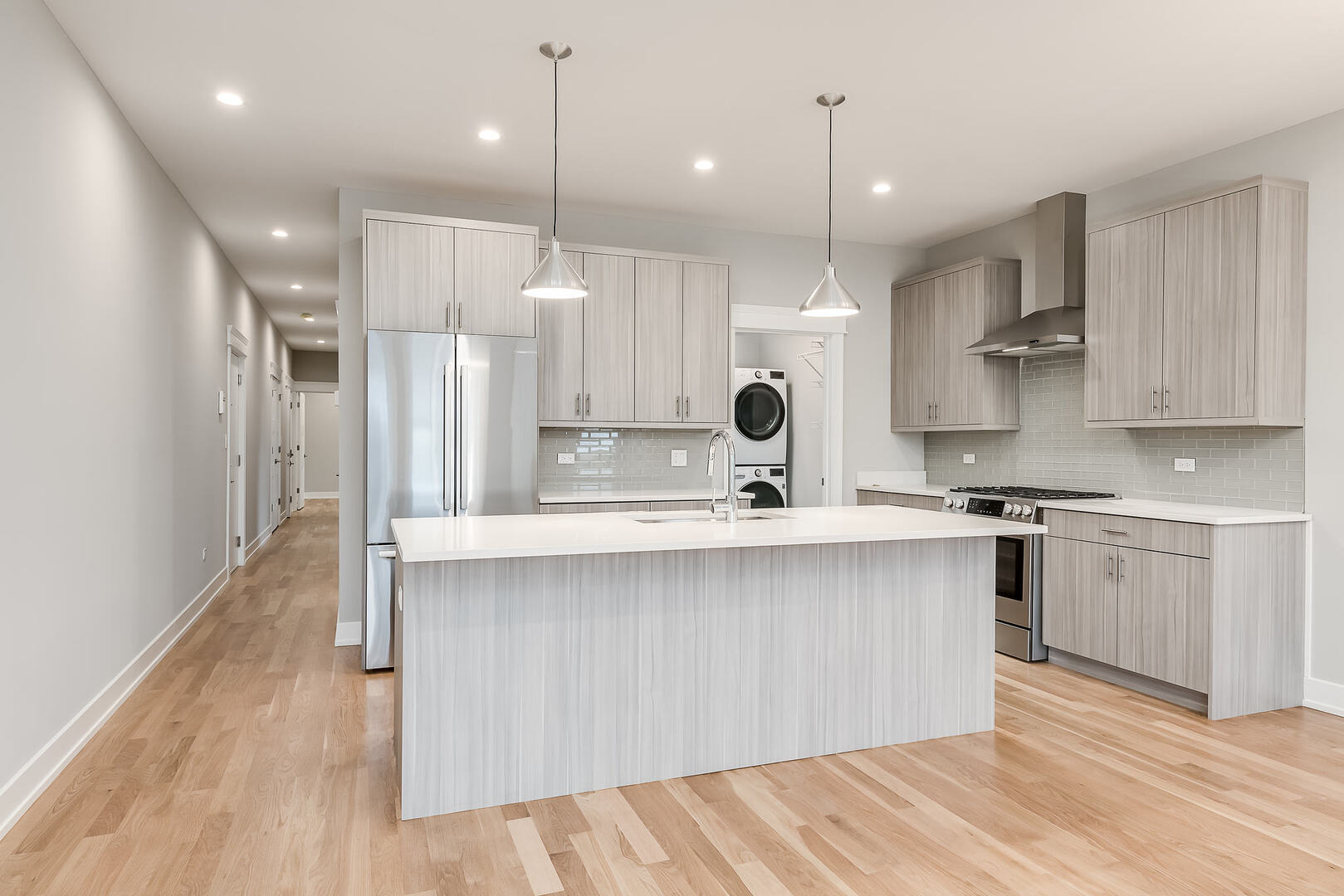 2145 South Halsted Street, Unit 4S Chicago, IL 60608 - Photo 4 of 29 a large kitchen with stainless steel appliances kitchen island a large island in the center