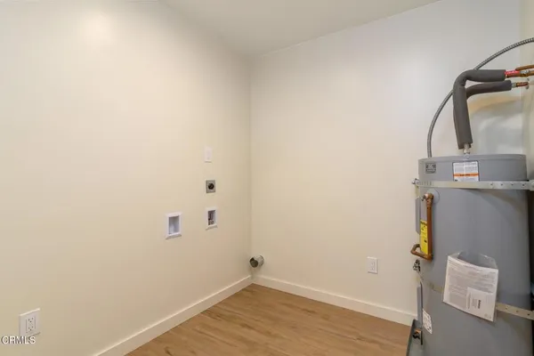 a view of a room with wooden floor and utility room