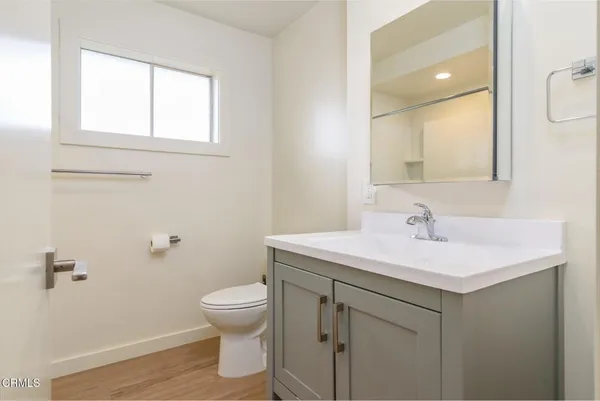 a bathroom with a sink toilet and a mirror