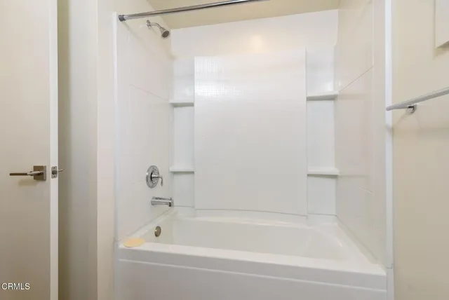 a bathroom with a shower and a bath tub