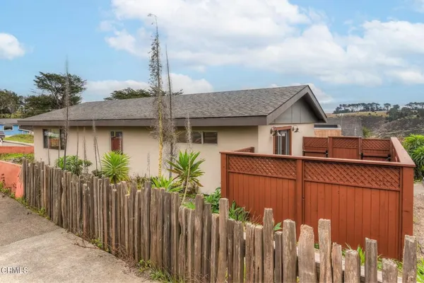 a front view of a house with wooden fence