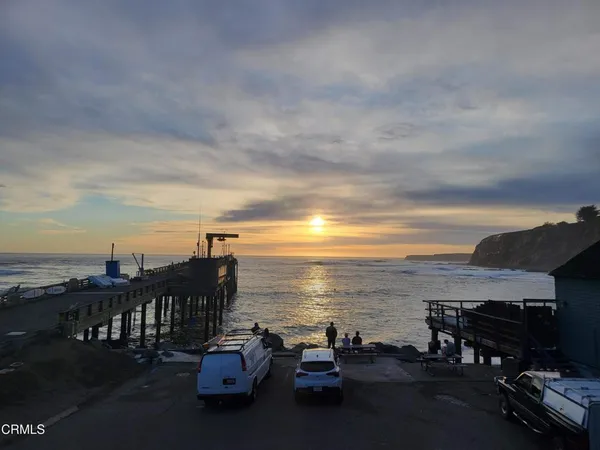a view of a terrace with lawn chairs