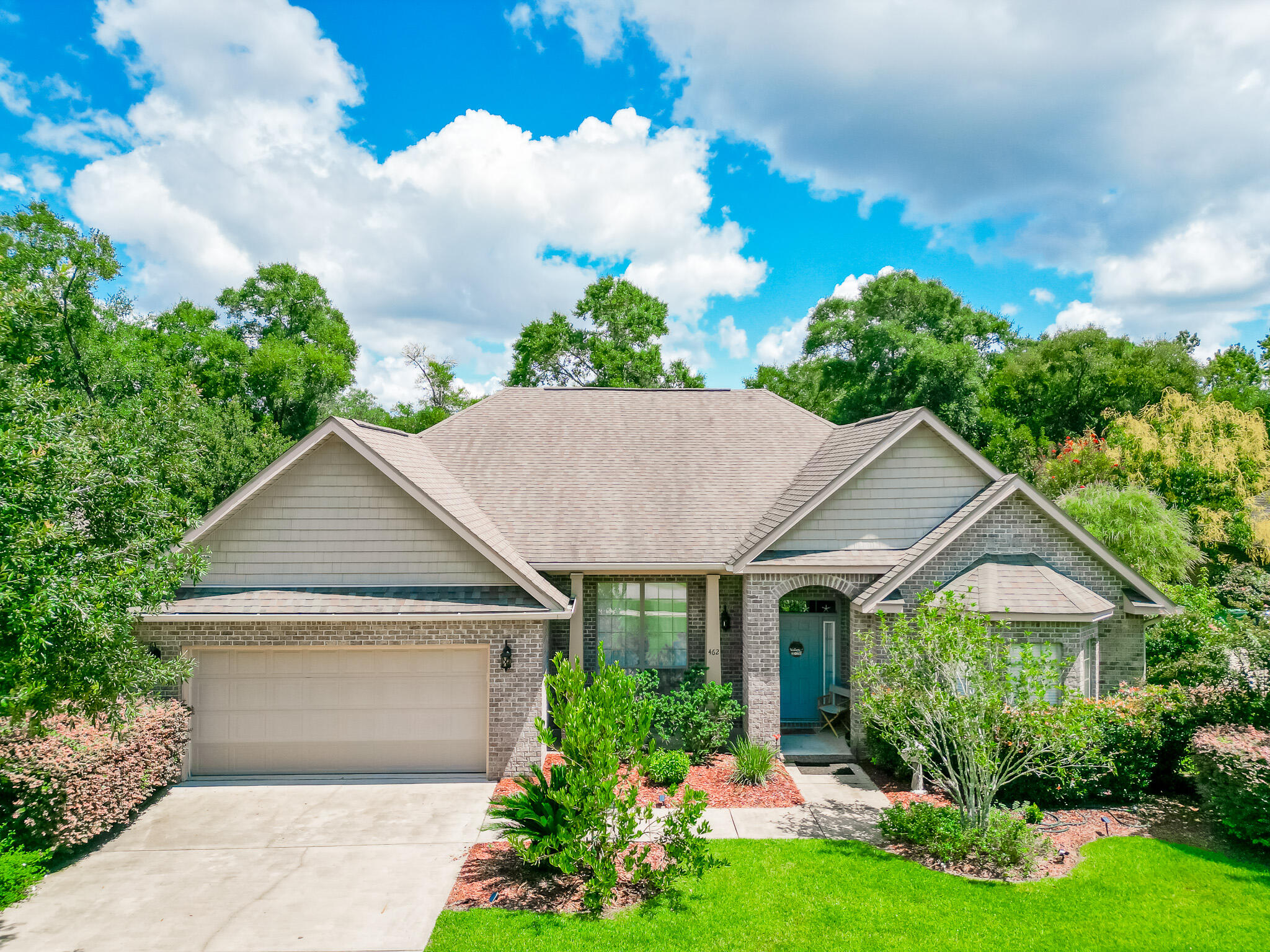 a front view of a house with garden