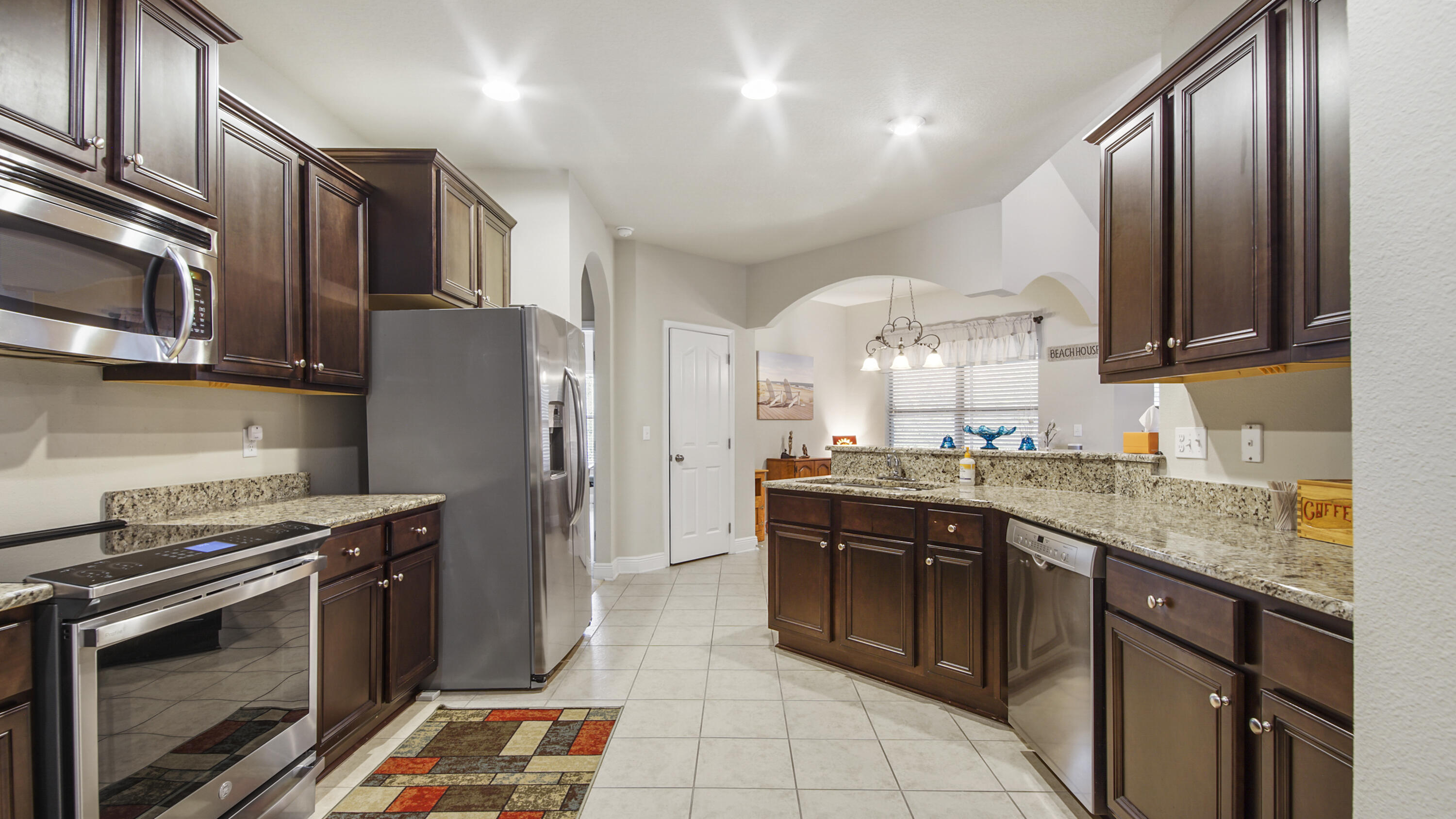 462 Mango Lane Freeport, FL 32439 - Photo 13 of 67 a kitchen with stainless steel appliances granite countertop a stove refrigerator sink and microwave