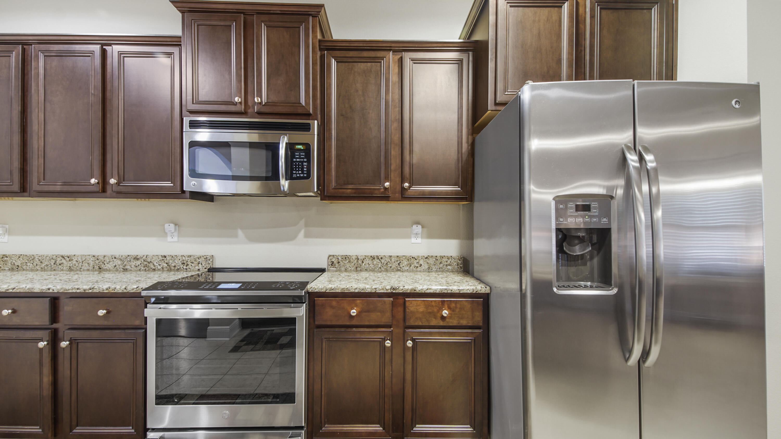 462 Mango Lane Freeport, FL 32439 - Photo 14 of 67 a kitchen with granite countertop a refrigerator and a stove