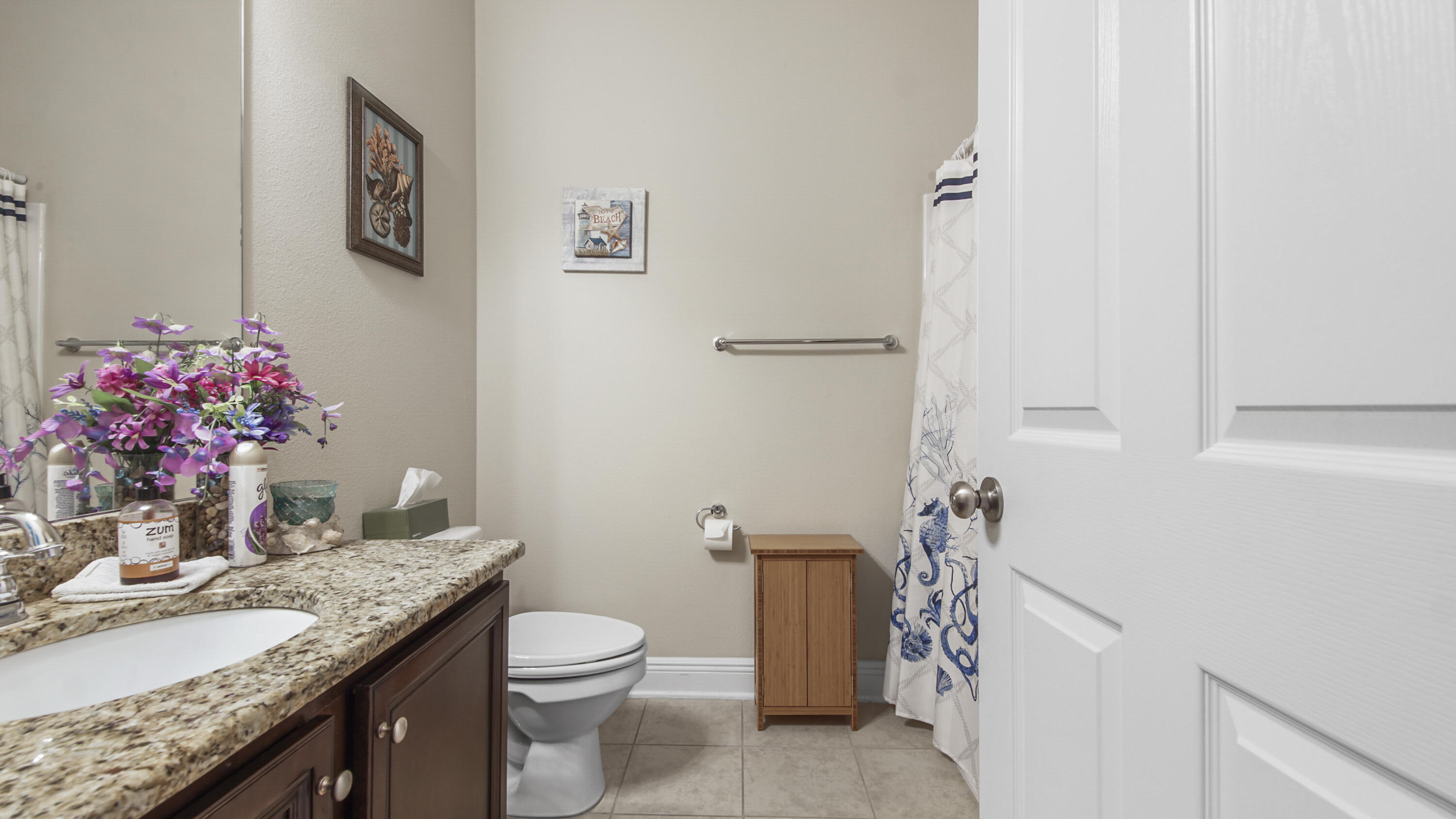 462 Mango Lane Freeport, FL 32439 - Photo 25 of 67 a bathroom with a granite countertop sink a toilet and a mirror