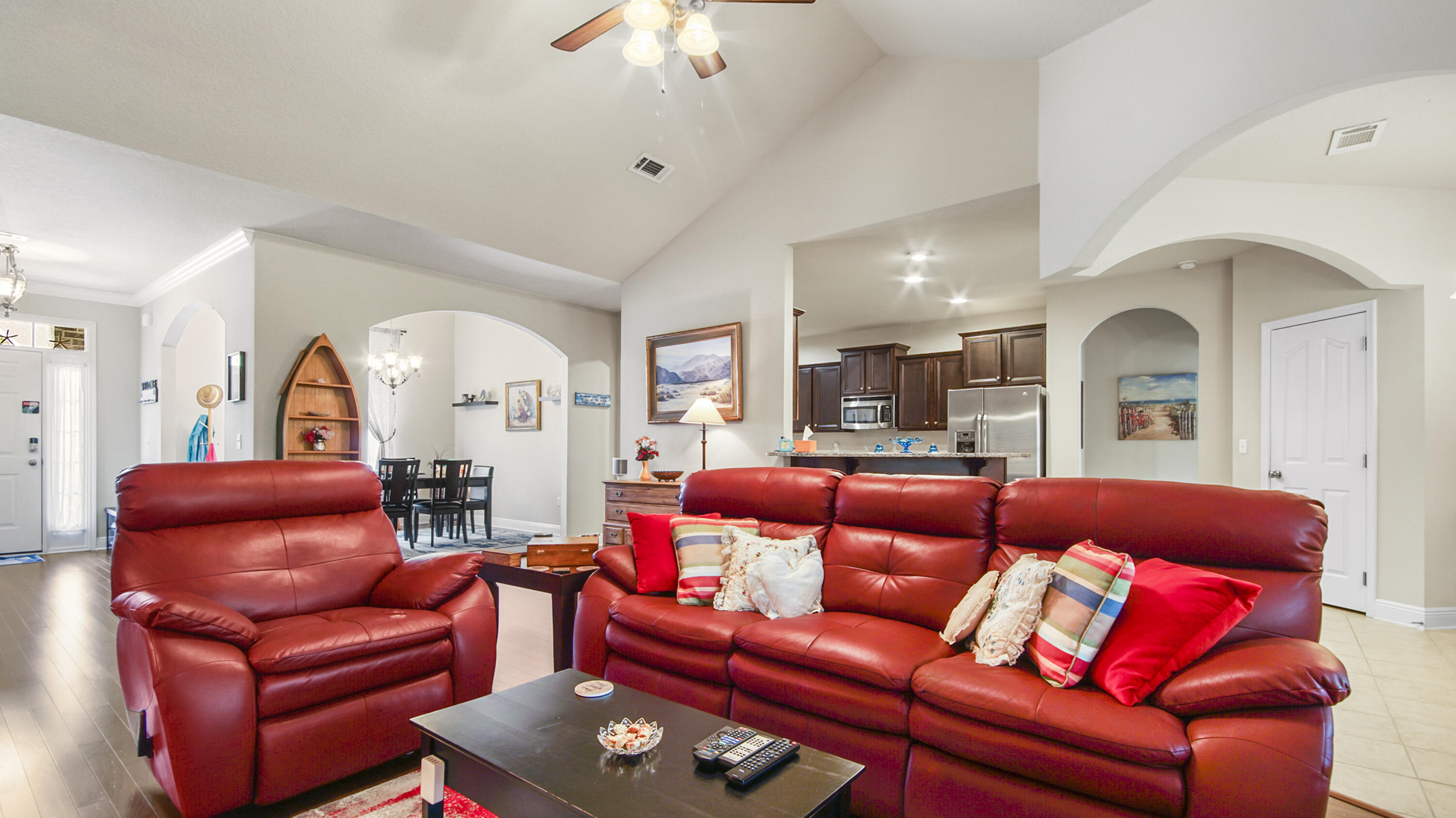 462 Mango Lane Freeport, FL 32439 - Photo 9 of 67 a living room with furniture a red couch and a chandelier