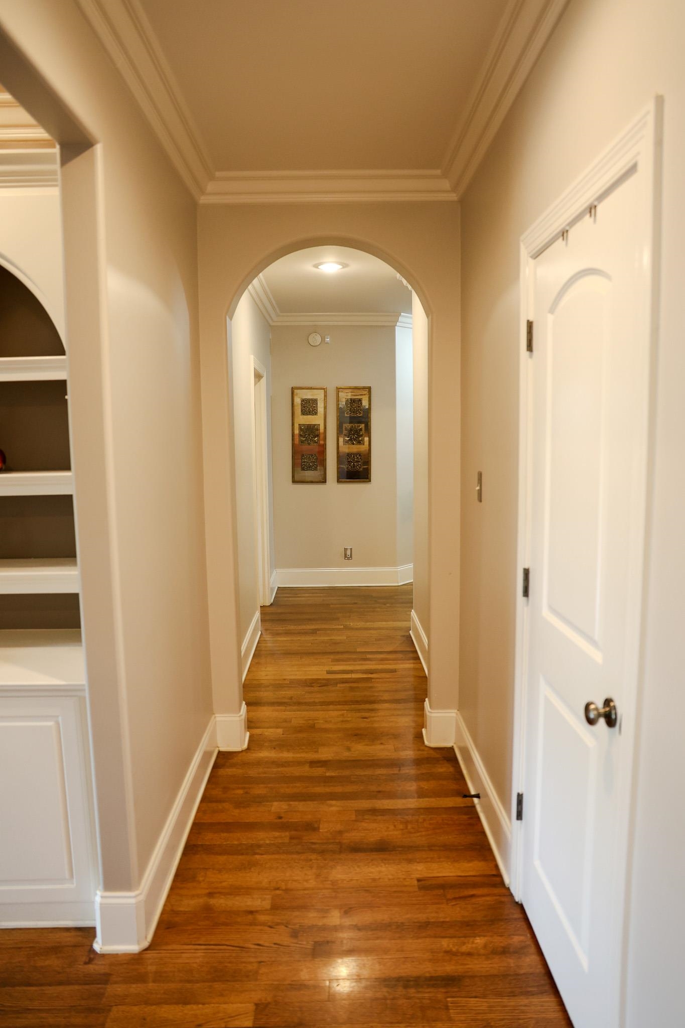 649 Ridge Springs Road Collierville, TN 38017 - Photo 19 of 35 Corridor featuring dark wood-style floors, arched walkways, and ornamental molding