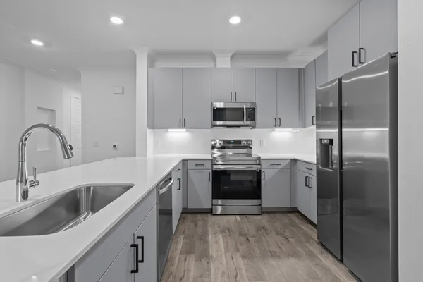 a kitchen with a refrigerator sink and microwave