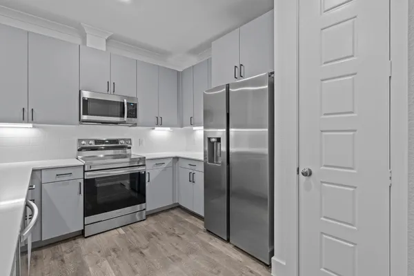 a kitchen with a refrigerator sink and stove