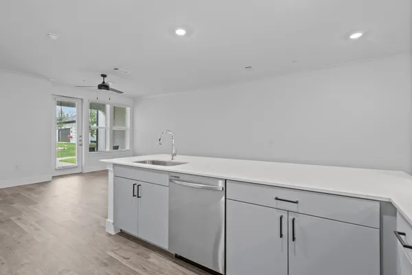 a kitchen with stainless steel appliances granite countertop a refrigerator stove and sink