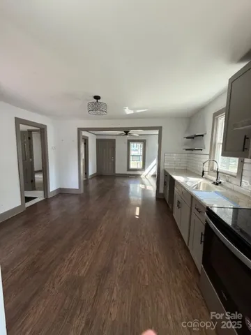 a view of a livingroom with wooden floor and windows