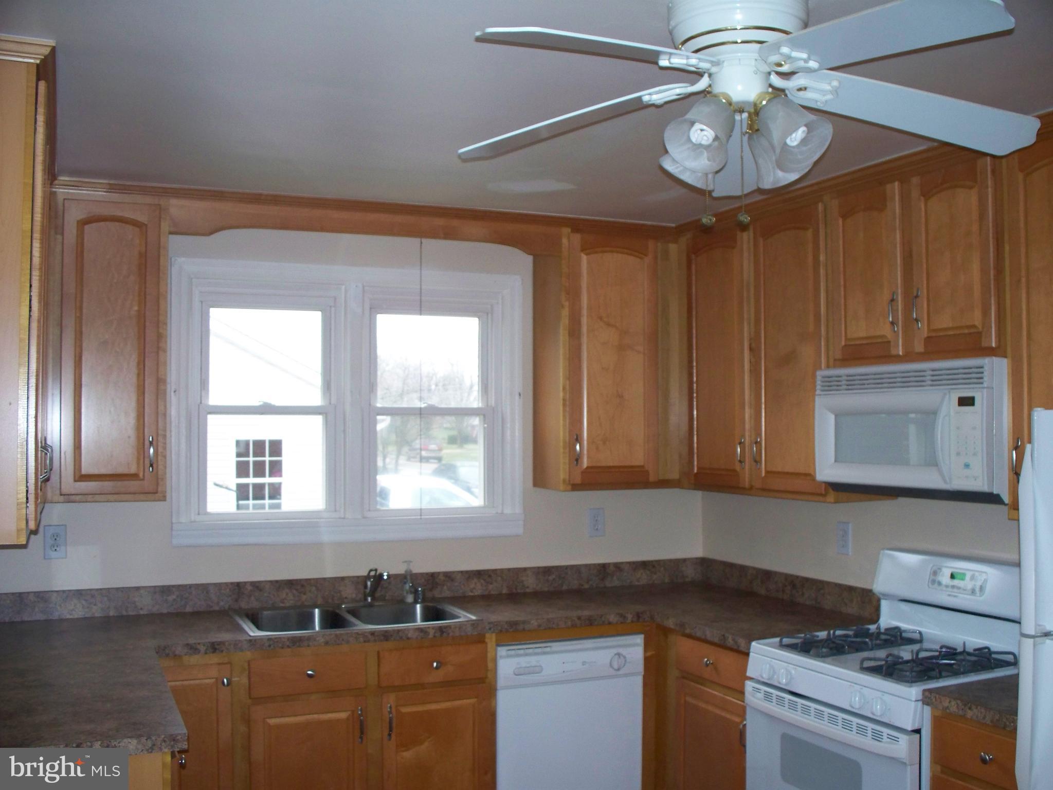 2618 Rocks Road Forest Hill, MD 21050 - Photo 7 of 20 a kitchen with stainless steel appliances granite countertop a sink cabinets a stove and a window