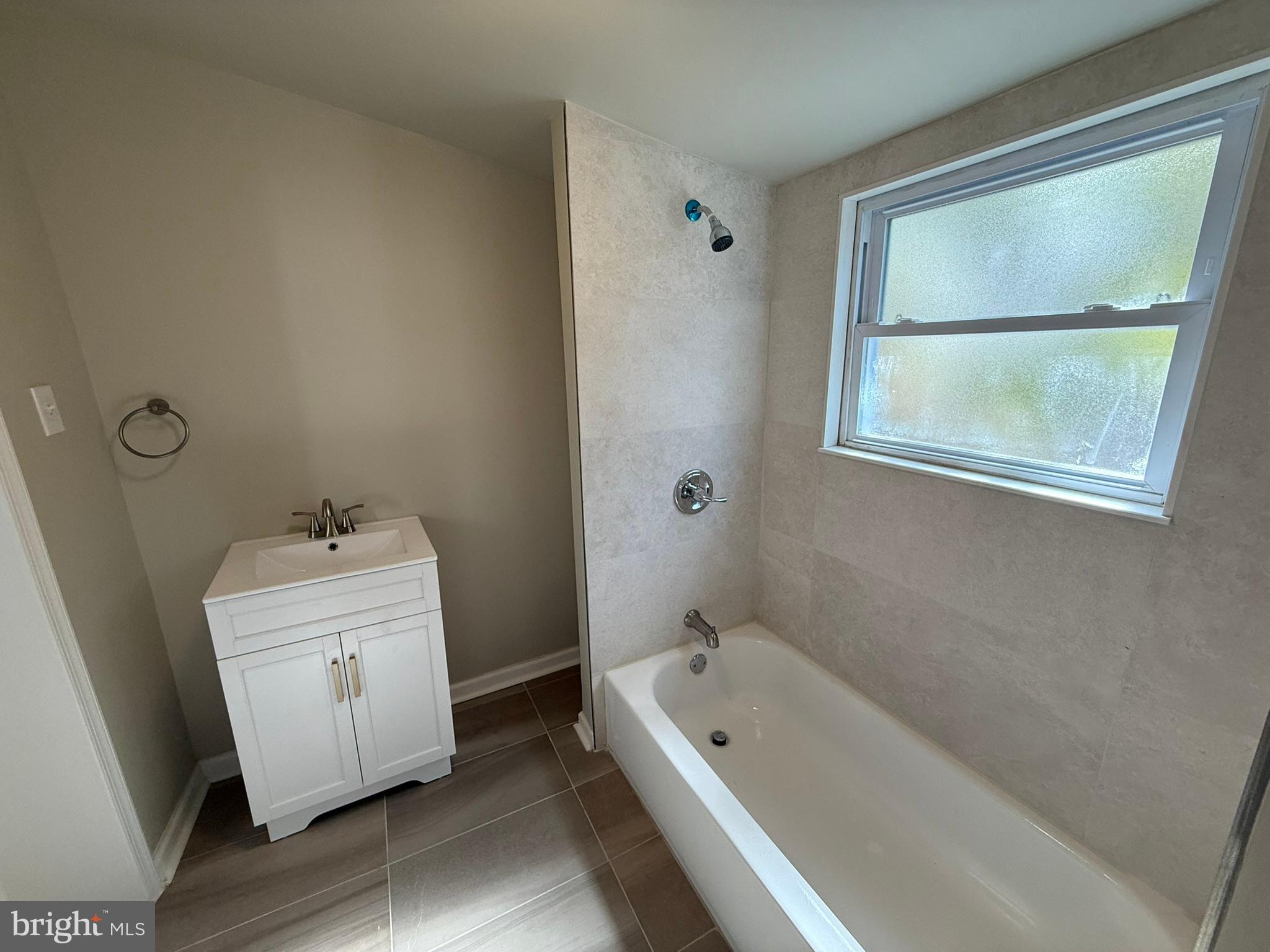 5618 Cedar Avenue, Unit 1 Philadelphia, PA 19143 - Photo 12 of 20 a bathroom with a tub sink and window