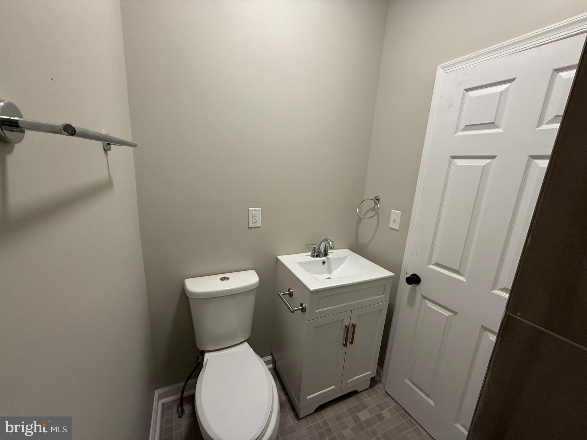 5618 Cedar Avenue, Unit 1 Philadelphia, PA 19143 - Photo 17 of 20 a bathroom with a toilet sink and mirror