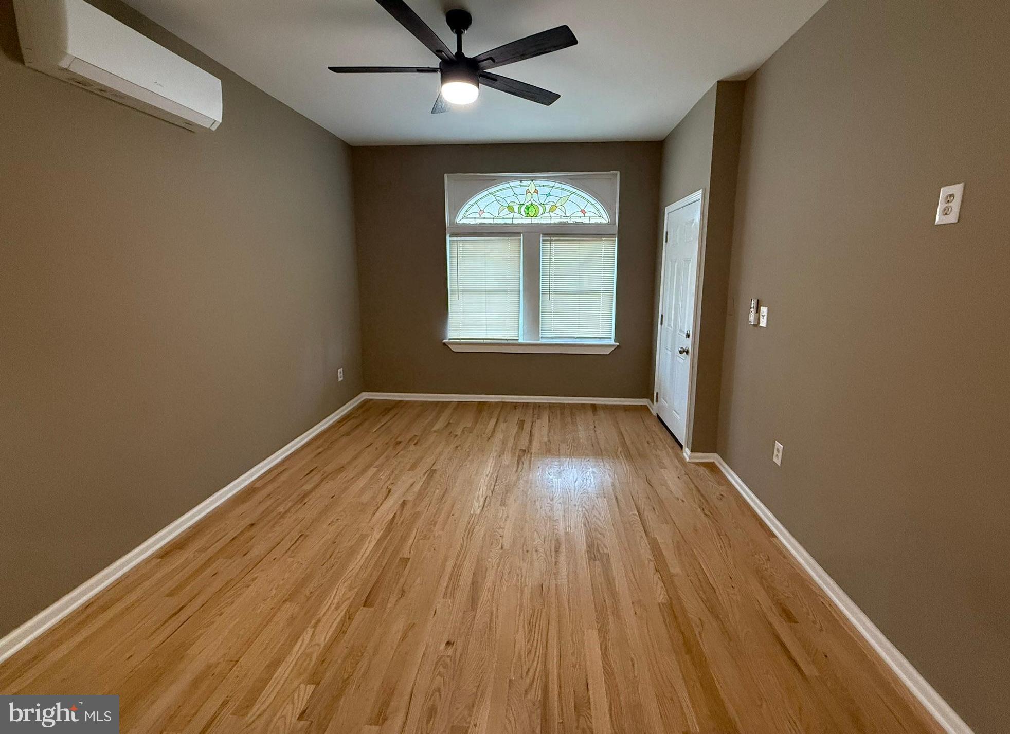 5618 Cedar Avenue, Unit 1 Philadelphia, PA 19143 - Photo 5 of 20 wooden floor in an empty room with a window