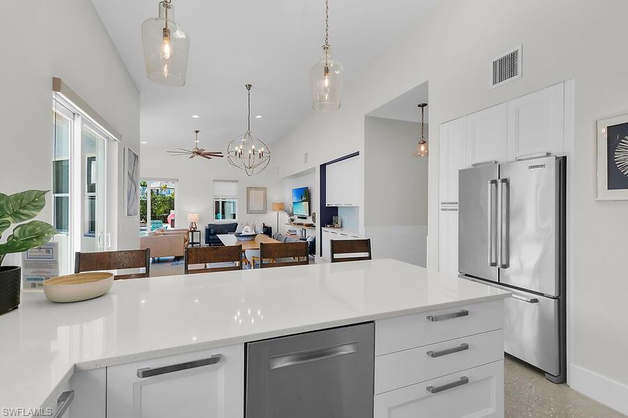 255 Columbus Way Marco Island, FL 34145 - Photo 12 of 50 a kitchen with cabinets a sink and stainless steel appliances